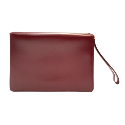 305 - A Cartier Burgundy Must de Cartier Wallet. Burgundy leather exterior, featuring gold-toned hardware ... 