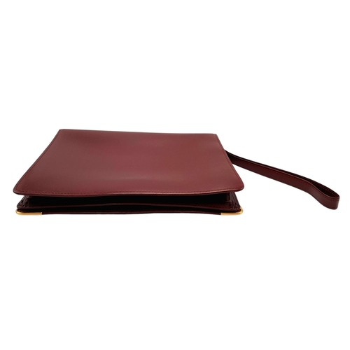 305 - A Cartier Burgundy Must de Cartier Wallet. Burgundy leather exterior, featuring gold-toned hardware ... 