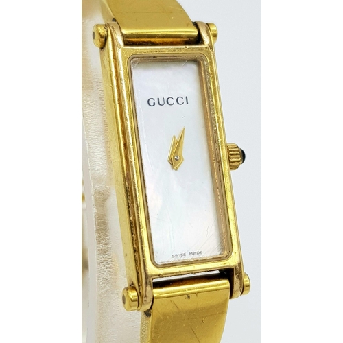 396 - A Gucci Gold Plated Ladies Quartz Watch. Gold plated bracelet and case - 12mm width. Mother of pearl... 