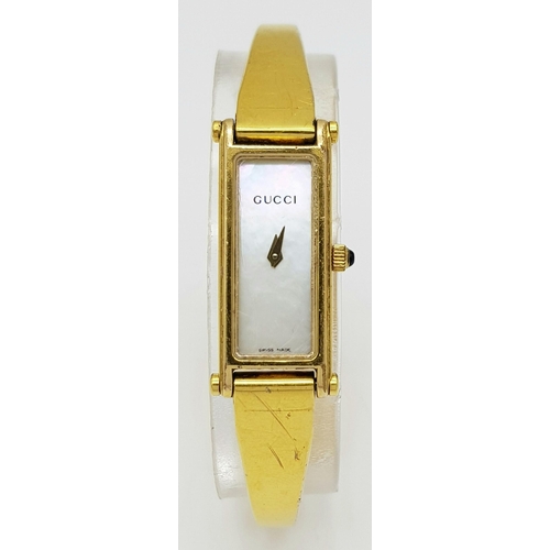 396 - A Gucci Gold Plated Ladies Quartz Watch. Gold plated bracelet and case - 12mm width. Mother of pearl... 