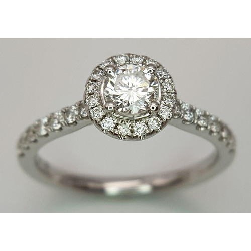 40 - AN 18K WHITE GOLD DIAMOND HALO SOLITAIRE RING, 0.30CT MAIN ROUND BRILLIANT CUT CENTRE STONE, WITH 0.... 