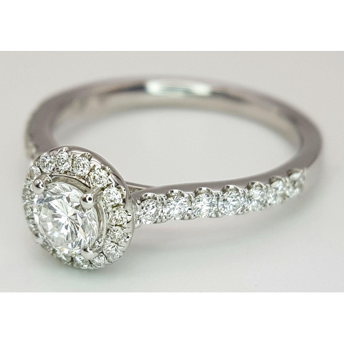 40 - AN 18K WHITE GOLD DIAMOND HALO SOLITAIRE RING, 0.30CT MAIN ROUND BRILLIANT CUT CENTRE STONE, WITH 0.... 