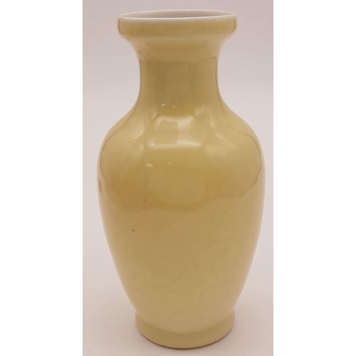 716 - An Antique Guangxu Chinese Cream Porcelain Vase. markings on base. 15cm tall.