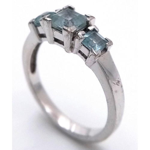 810 - A Sterling Silver Aquamarine Set Trilogy Ring Size O. Set with Three Square Cut Aquamarines, the lar... 