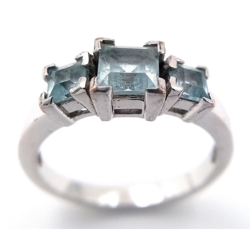 810 - A Sterling Silver Aquamarine Set Trilogy Ring Size O. Set with Three Square Cut Aquamarines, the lar... 