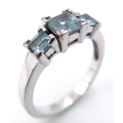 810 - A Sterling Silver Aquamarine Set Trilogy Ring Size O. Set with Three Square Cut Aquamarines, the lar... 