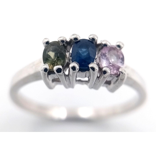 929 - A Sterling Silver Blue, Pink & Green Sapphire Trilogy Ring Size P1/2. Set with three 5mm Length Oval... 