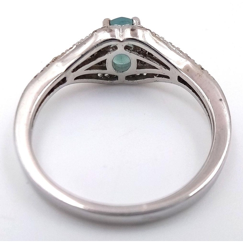 935 - Sterling Silver Aquamarine and White Sapphire Set Ring Size S. The Ring is set with a 7mm Oval Cut A... 