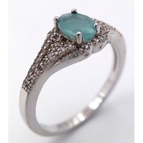 935 - Sterling Silver Aquamarine and White Sapphire Set Ring Size S. The Ring is set with a 7mm Oval Cut A... 