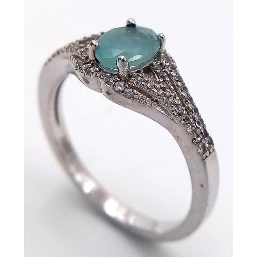 935 - Sterling Silver Aquamarine and White Sapphire Set Ring Size S. The Ring is set with a 7mm Oval Cut A... 