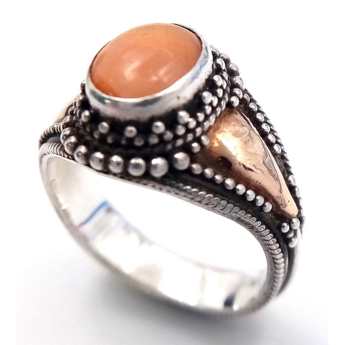 244 - Vintage 18 CARAT GOLD and SILVER RING. Having PEACH MOONSTONE CABOCHON set to top. Complete with rin... 