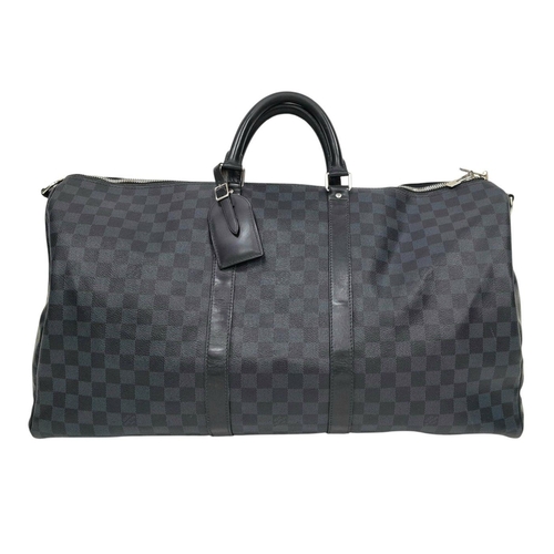 25 - A Louis Vuitton Blue and Black Damier Keepall 55 Bag. Blue and black Damier canvas exterior with bla... 