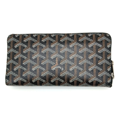 278 - A Goyard Monogram Zipped Wallet. Brown canvas exterior with silver-toned hardware and a zipped closu... 