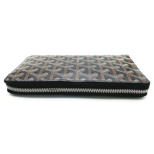 278 - A Goyard Monogram Zipped Wallet. Brown canvas exterior with silver-toned hardware and a zipped closu... 