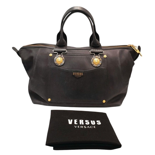 326 - A Versus Versace Leather Shoulder Bag. Black leather exterior with gold-toned hardware. Lion medalli... 