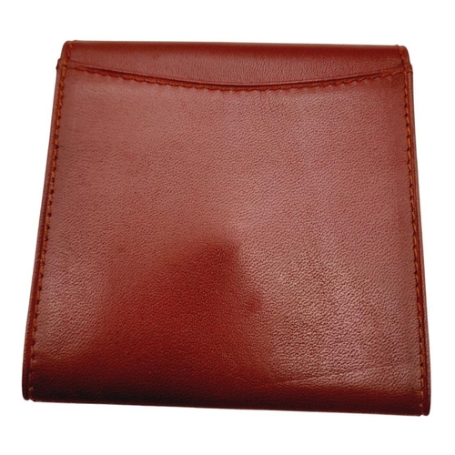 395 - A Cartier Paris Brown Leather Coin Wallet. Leather exterior with gold-toned hardware and snap button... 