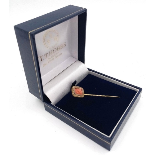 547 - Antique yellow metal TIE STICK PIN with CARVED CORAL FINIAL. 1.2 grams. 5.5 cm.