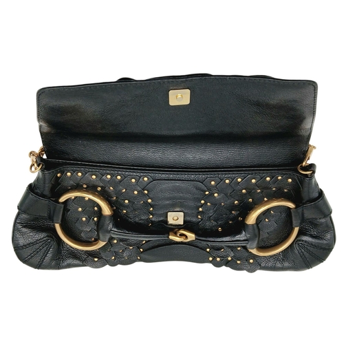 90 - A Gucci Studded Black Leather Shoulder Bag. Black leather exterior with gold toned hardware and stud... 