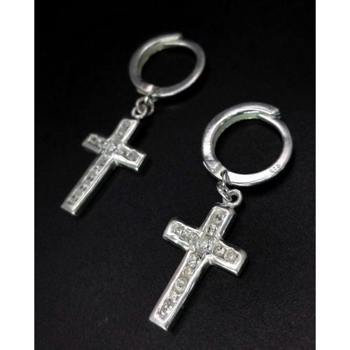 1104 - A PAIR OF STERLING SILVER HOOP EARRINGS WITH STONE SET CROSS DROPS. 2.4G. SC3081.