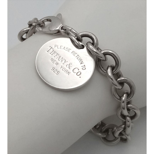 106 - A Vintage Tiffany Sterling Silver Bracelet with Tiffany Circular Charm. 16cm. 38g. Comes with a Tiff... 