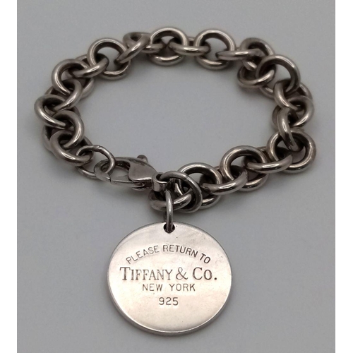 106 - A Vintage Tiffany Sterling Silver Bracelet with Tiffany Circular Charm. 16cm. 38g. Comes with a Tiff... 