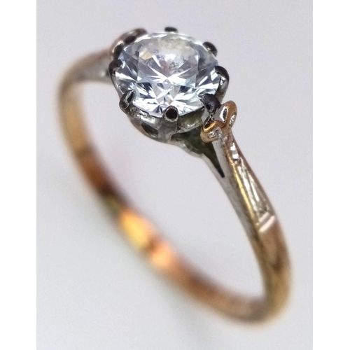 1114 - Impressive vintage 9 carat GOLD, ZIRCONIA SOLITAIRE RING. Having fancy shoulders with a sparkling 0.... 