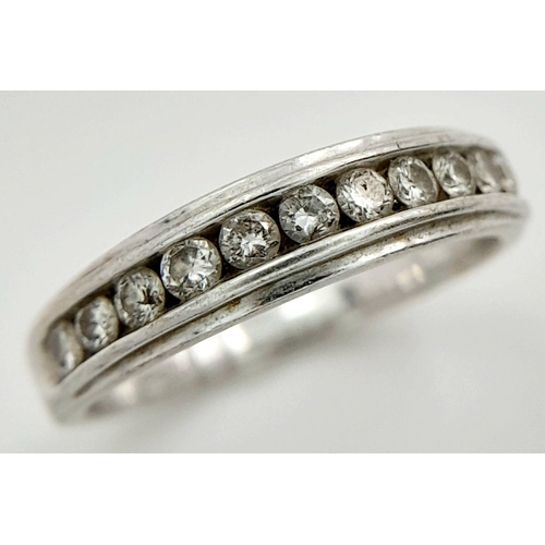 135 - AN 18K WHITE GOLD RING WITH 11 CHANNEL SET SMALL DIAMONDS .   3.3gms    size L