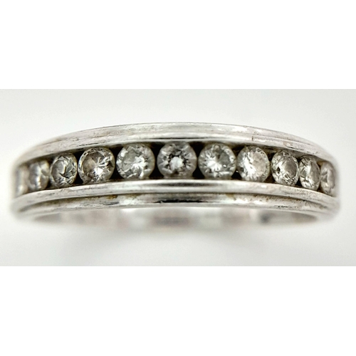 135 - AN 18K WHITE GOLD RING WITH 11 CHANNEL SET SMALL DIAMONDS .   3.3gms    size L