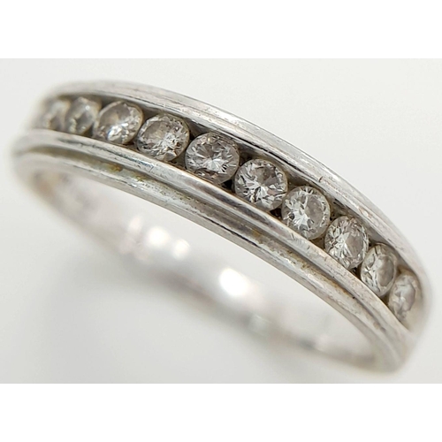 135 - AN 18K WHITE GOLD RING WITH 11 CHANNEL SET SMALL DIAMONDS .   3.3gms    size L