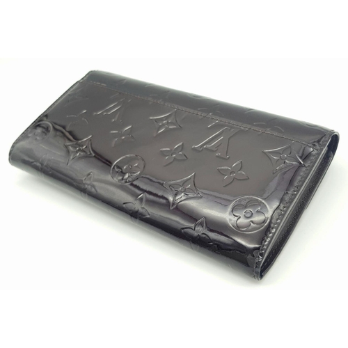 178 - A Louis Vuitton Patent Leather Purse/Wallet. Monogram exterior. Leather interior with zipped and ope... 