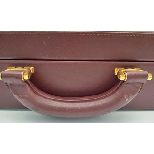 262 - A Must de Cartier Burgundy Leather Briefcase. Burgundy leather exterior with gold-toned hardware. On... 