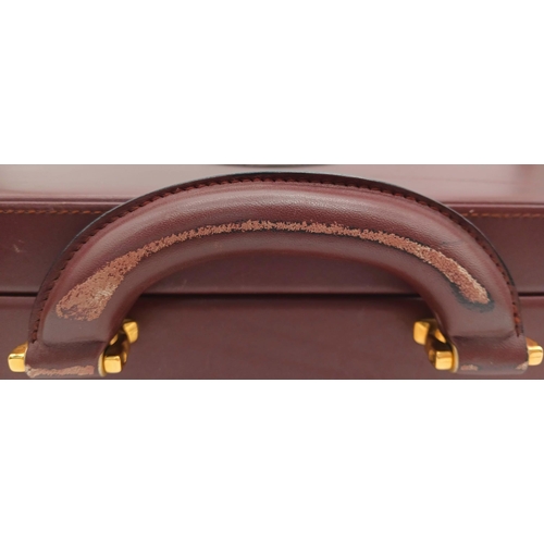 262 - A Must de Cartier Burgundy Leather Briefcase. Burgundy leather exterior with gold-toned hardware. On... 