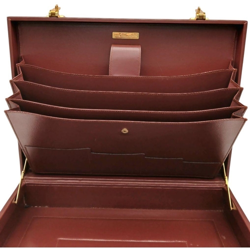 262 - A Must de Cartier Burgundy Leather Briefcase. Burgundy leather exterior with gold-toned hardware. On... 