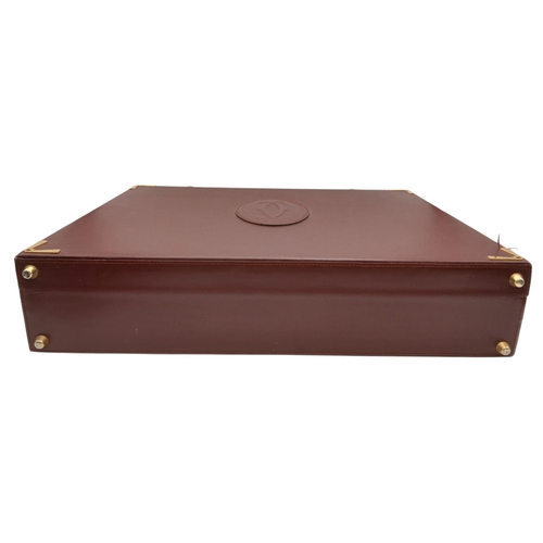 262 - A Must de Cartier Burgundy Leather Briefcase. Burgundy leather exterior with gold-toned hardware. On... 