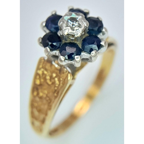 277 - A VINTAGE 18K GOLD RING WITH SAPPHIRES AND SMALL CENTRAL DIAMOND AND DECORATIVE SHOULDERS .    3.3gm... 