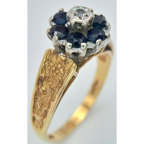 277 - A VINTAGE 18K GOLD RING WITH SAPPHIRES AND SMALL CENTRAL DIAMOND AND DECORATIVE SHOULDERS .    3.3gm... 