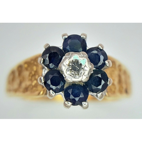 277 - A VINTAGE 18K GOLD RING WITH SAPPHIRES AND SMALL CENTRAL DIAMOND AND DECORATIVE SHOULDERS .    3.3gm... 