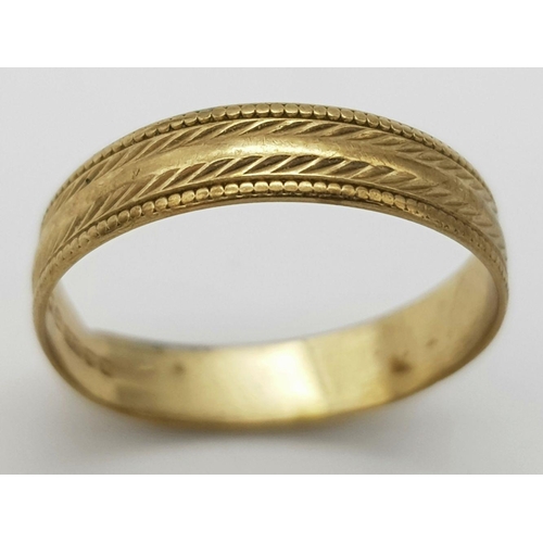 374 - A 9K GOLD BAND RING WITH PATTERNED SHANK .    1.2gms    size M