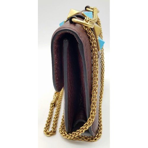 53 - A Valentino Rockstud Burgundy Leather Crossbody Bag. Leather exterior with gold-toned hardware, chai... 