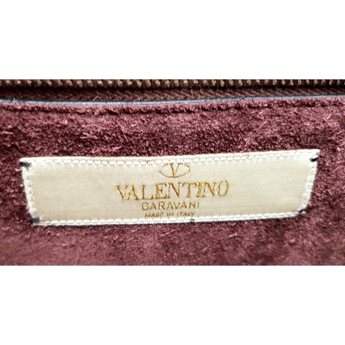 53 - A Valentino Rockstud Burgundy Leather Crossbody Bag. Leather exterior with gold-toned hardware, chai... 