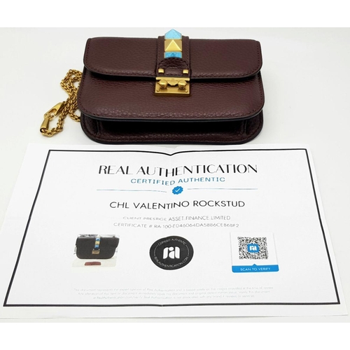 53 - A Valentino Rockstud Burgundy Leather Crossbody Bag. Leather exterior with gold-toned hardware, chai... 