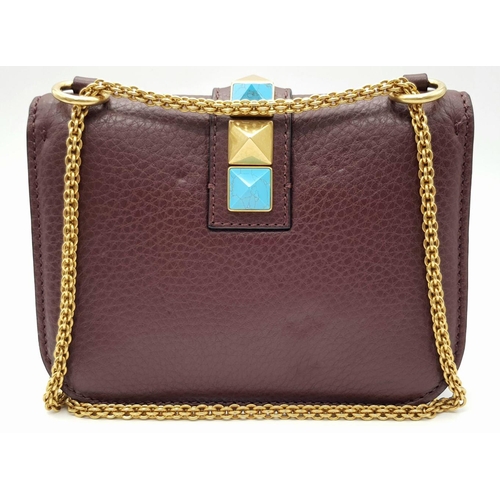 53 - A Valentino Rockstud Burgundy Leather Crossbody Bag. Leather exterior with gold-toned hardware, chai... 