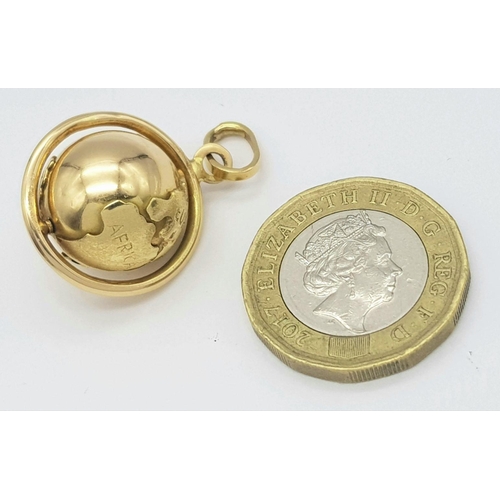 8 - A REALLY UNUSUAL 18K GOLD ROTATING GLOBE PENDANT- THE WORLD IS YOUR OYSTER .      7.2gms