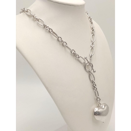 888 - A STERLING SILVER FANCY LINK NECKLACE WITH BARKED FINISH HEART PENDANT 21.3G. Ref: H 5003