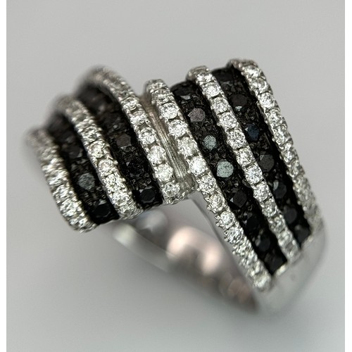 50 - A 14K WHITE GOLD, BLACK AND WHITE DIAMOND CROSSOVER RING. SOPHISTICATED, LOVELY DESIGN. 7.8G. SIZE N... 