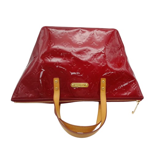 82 - A Louis Vuitton Red Vernis Alma PM Bag. Vernis leather exterior with gold-toned hardware, dual top h... 