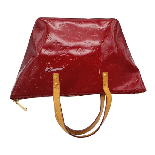 82 - A Louis Vuitton Red Vernis Alma PM Bag. Vernis leather exterior with gold-toned hardware, dual top h... 