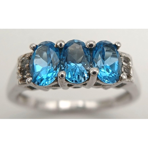 1013 - A Sterling Silver, Blue and White Topaz Set Ring Size O. The Ring is Set with 6mm Long Oval Cut Blue... 