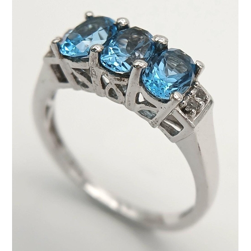 1013 - A Sterling Silver, Blue and White Topaz Set Ring Size O. The Ring is Set with 6mm Long Oval Cut Blue... 