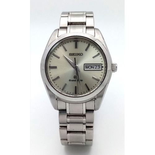 176 - A Vintage Grand Seiko Quartz Gents Watch. Stainless steel bracelet and case - 37mm. Silver tone dial... 